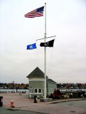 Eugene O'Neill Centennial Statue next to Flagpole in New London, CT